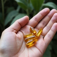 Glowthery Men's Vitality Complex capsules in a hand