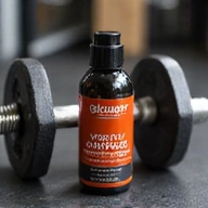 Glowthery Men's Vitality Complex bottle next to gym equipment